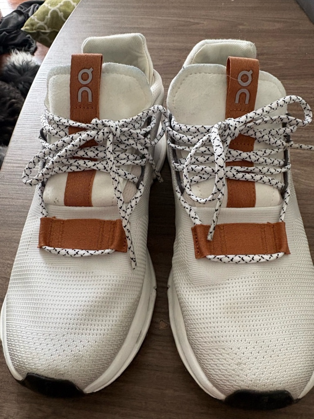 On Cloud white sneakers with tan accents